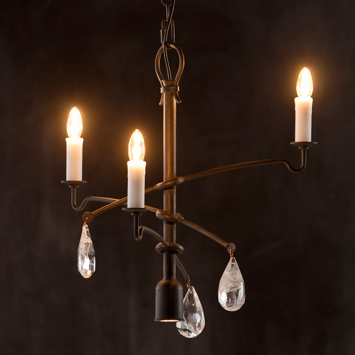 Candlestick with hanging crystal drops and downward spotlight