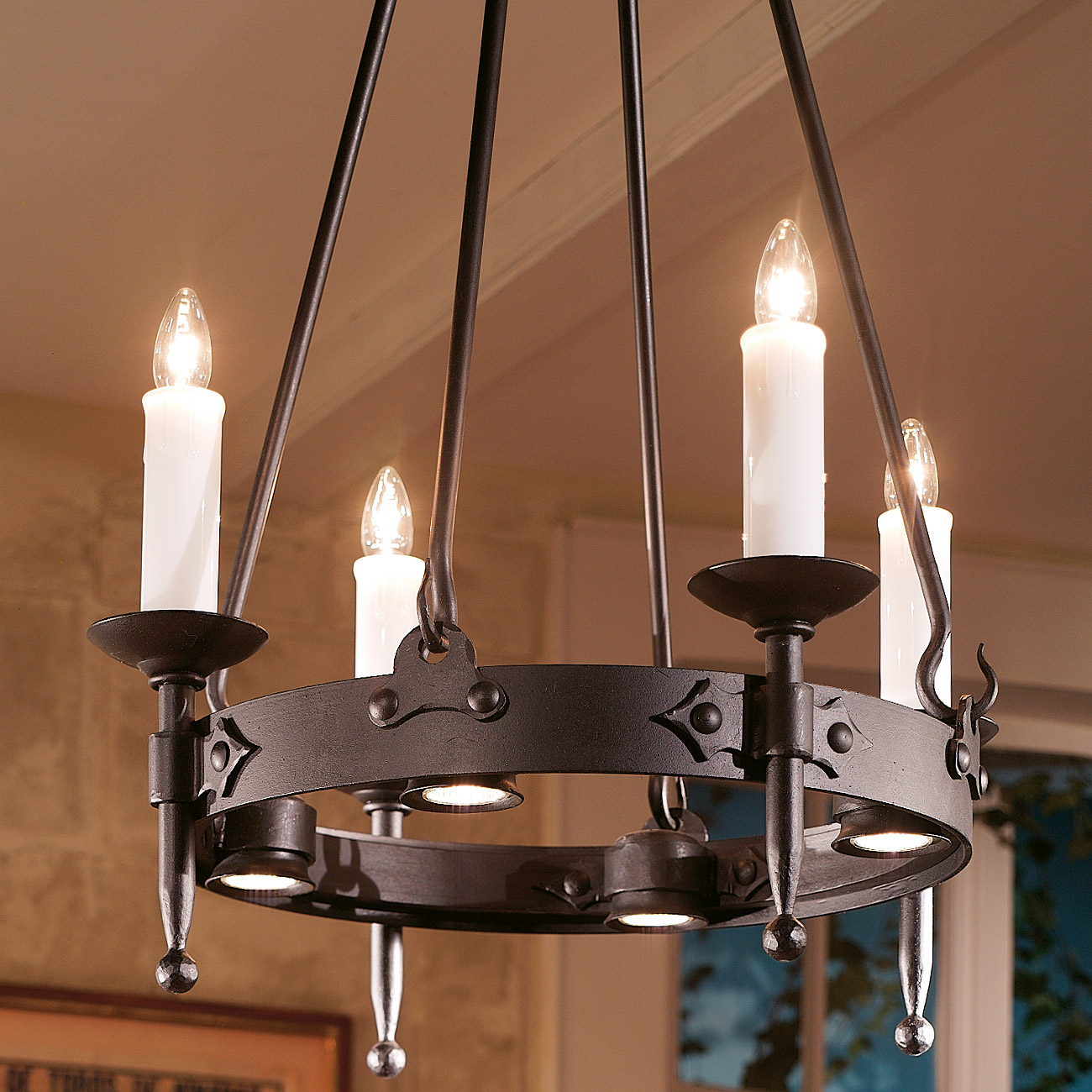 Wrought iron candle-holder with downard spotlights